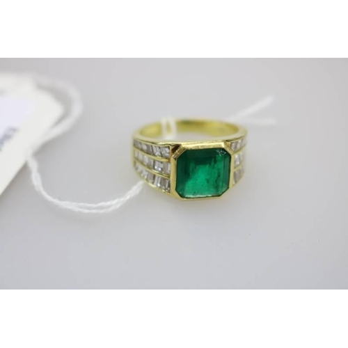 332 - An 18ct gold (unhallmarked) Emerald ring set with a total of 36 baguette cut small diamonds