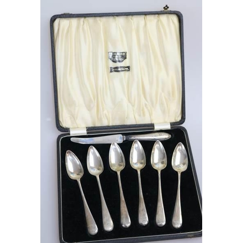 69 - Six silver cased teaspoons together with a knife.