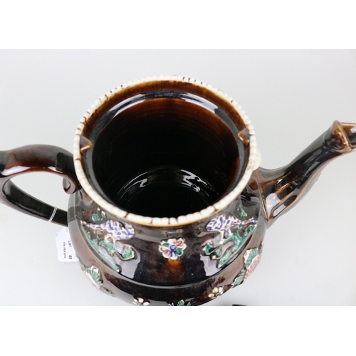 85 - An antique treacle glaze barge ware teapot with message to the front 