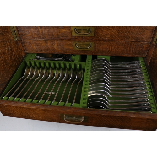 215 - An Oak canteen of cutlery enclosed by two doors contents as shown in images