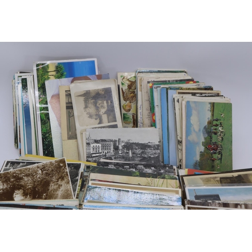 21 - A carton full of postcards of mixed years and themes