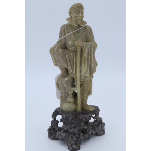 36 - Decoratively carved soapstone traveller on base (measures approx 21cm high)