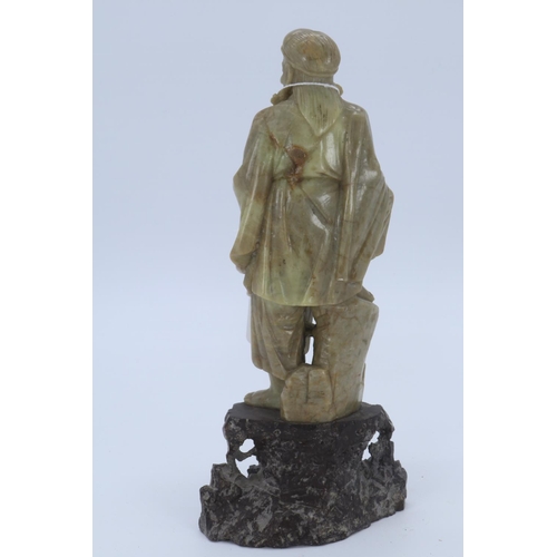 36 - Decoratively carved soapstone traveller on base (measures approx 21cm high)