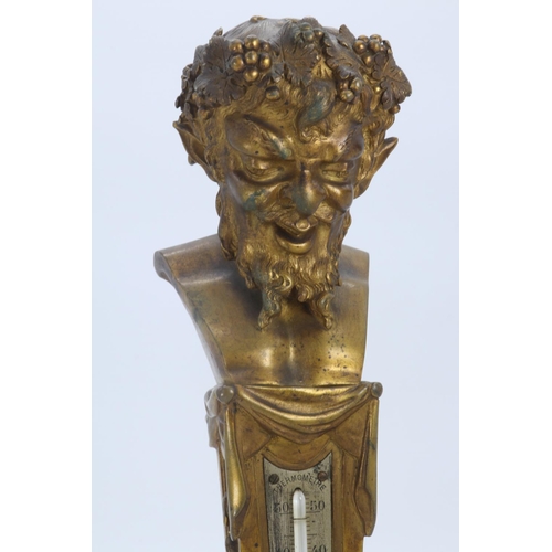 41 - An antique decorative gilt bronze thermometer decorated with the bust of Baccus seated on column bas... 