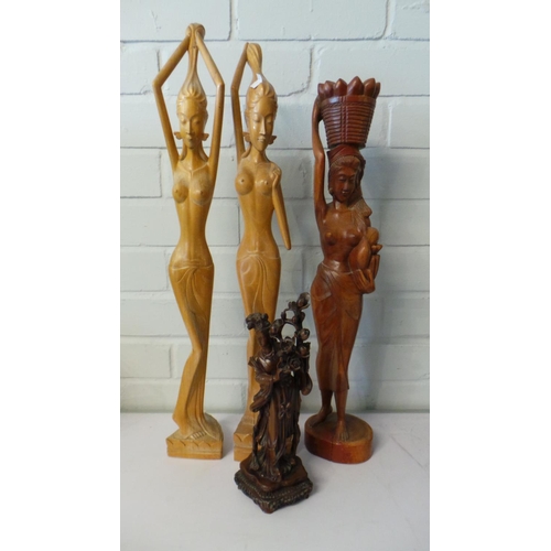 235 - Pair of tall hand carved semi nude figures made in Bali together with another oriental resin figure ... 