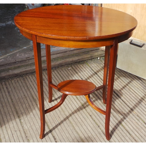 771 - An Edwardian oval mahogany line inlaid table measures approx 66cm w x 48cm d x 73cm h