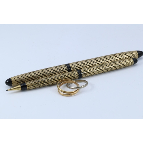 161 - Yellow metal triple ring together with a Schafer fountain pen and pencil