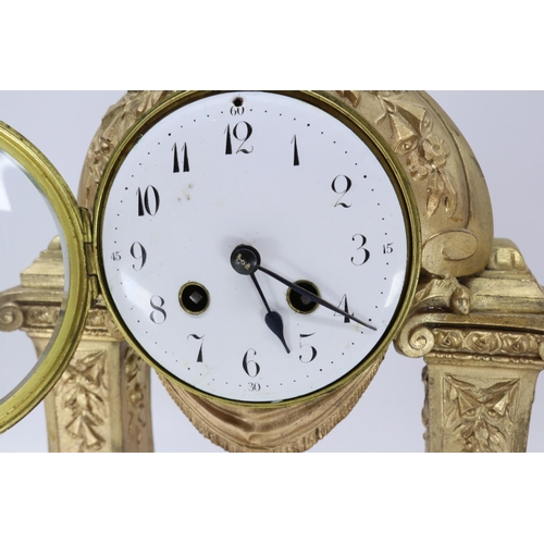 114 - A French clock with two garnitures