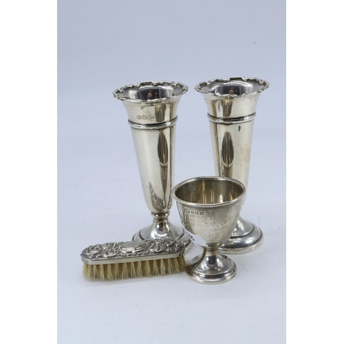 25 - Pair of silver spill vases, silver egg cup and a small silver nail brush