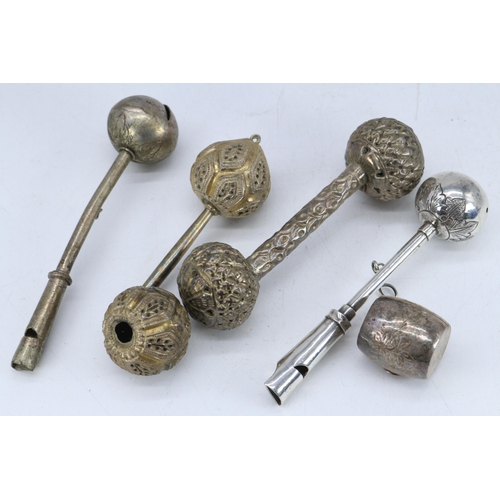 31 - Two white metal Eastern baby rattles, one a/f, similar whistle etc