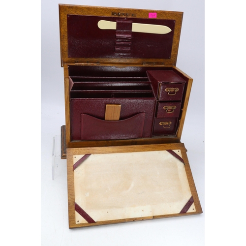 39 - An Art Noveau oak stationary case with repoussé copper decoration.