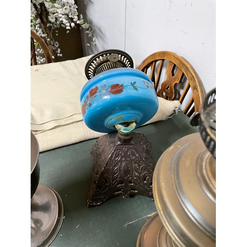 572 - Quantity of oil lamps and various glass shades