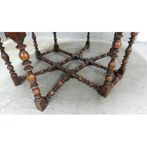 608 - An oak drop leaf dining table with bobbin style turned legs. It measures approx' closed 137 x 58 and... 