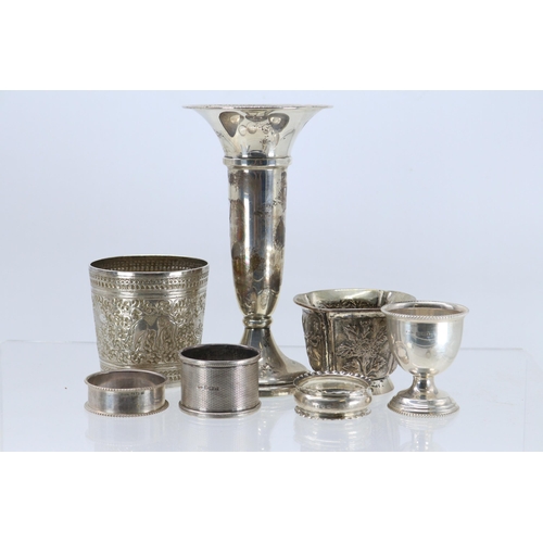 26 - A silver hallmarked trumpet vase, two eastern white metal pots, three hallmarked napkin rings and a ... 