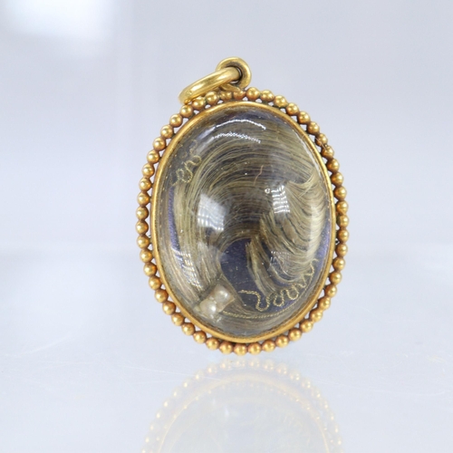 263 - Unmarked gold? mourning locket with domed glass either side together with two similar