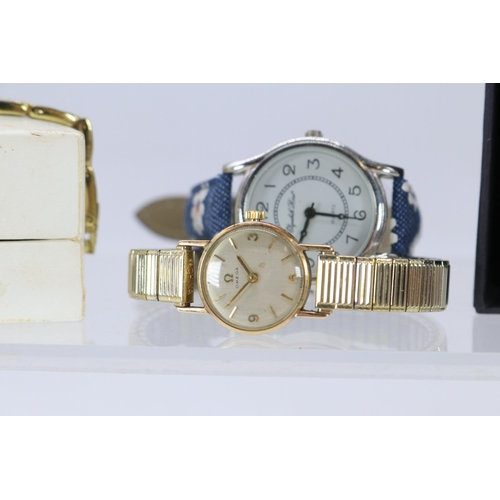 264 - Ladies Omega cocktail watch, Swarovski watch and three modern watches