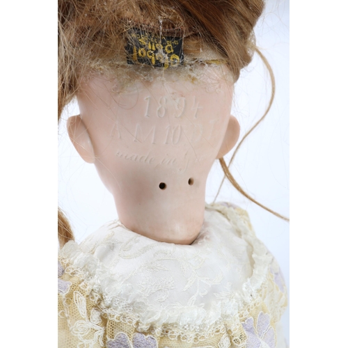 432 - A vintage porcelain head doll, approx. 24