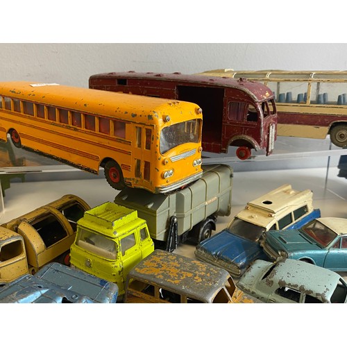 569 - A large quantity of mainly dinky toys playworn vehicles coaches, cars etc