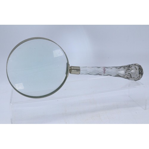 578 - An oversized glass handled magnifying glass together with a selection of glassware including coloure... 