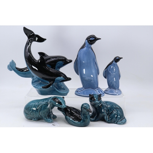 480 - A selection of Poole Pottery animals to include Dolphin, Penguins, badger and birds etc