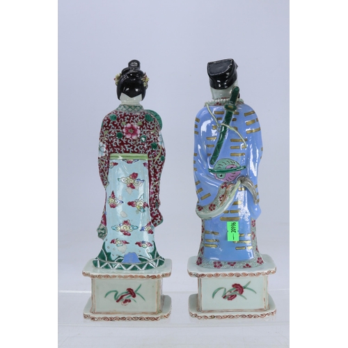 132 - A pair of Chinese Famille Rose figures (male figures has been restored on base and head)