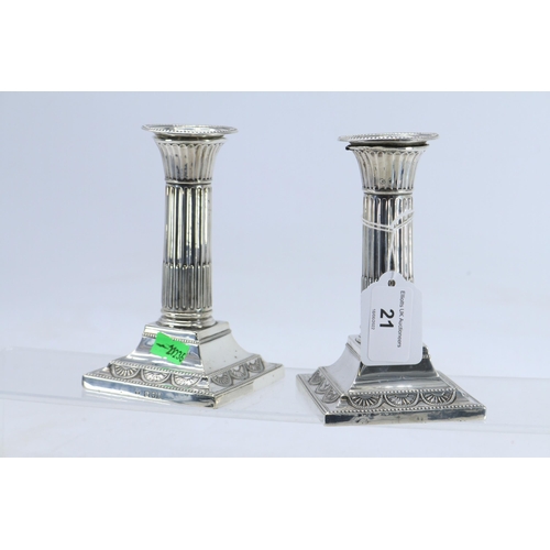 21 - A pair of silver candlesticks