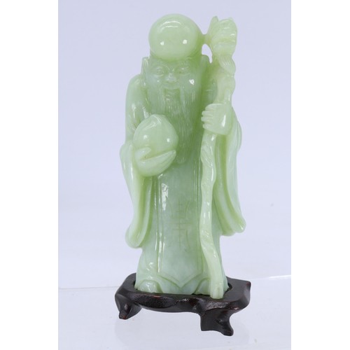 245 - Chinese jade figurine Immortal on wooden base together with another jade figurine on wooden stand.