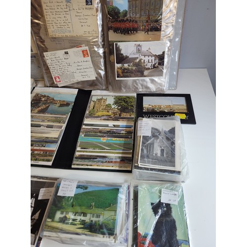 269a - Quantity of postcards in albums and loose  together with stamps