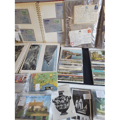 269a - Quantity of postcards in albums and loose  together with stamps