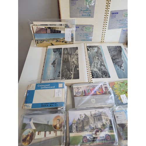 269a - Quantity of postcards in albums and loose  together with stamps