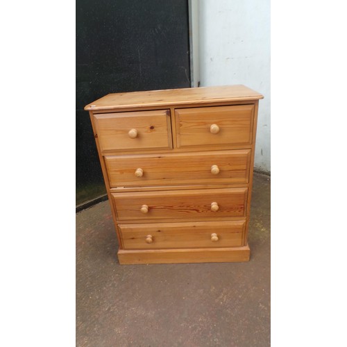 73 - Pine modern two door wardrobe together with a pine framed wall mirror and a modern pine chest of two... 