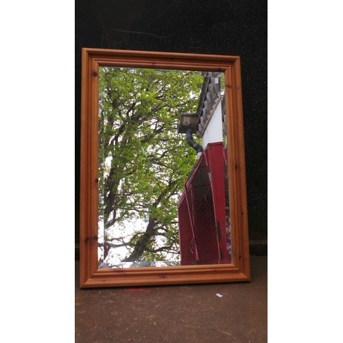 73 - Pine modern two door wardrobe together with a pine framed wall mirror and a modern pine chest of two... 