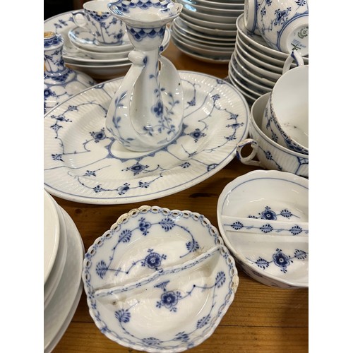 118 - A large collection of Copenhagen blue fluted ceramic in various styles including lace-edged pattern.... 