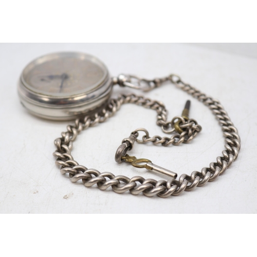 251 - A silver cased pocket watch and albert chain with a silver chased dial