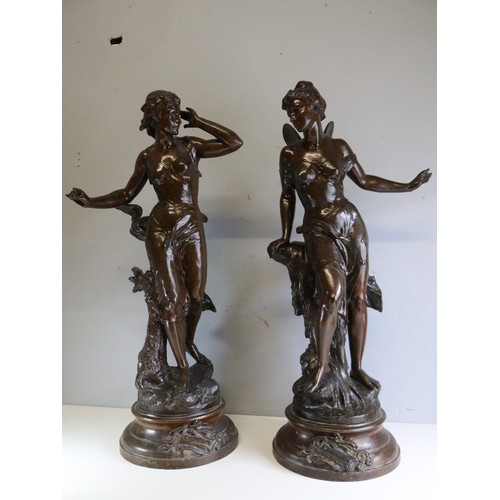 525 - Pair of large floor standing spelter figures with patinated bronze finish.