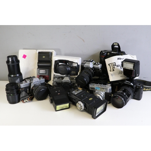 545 - A Nikon D70 camera body together with a Nikon F401 with 35-135mm lens and instructions, a minolta SR... 