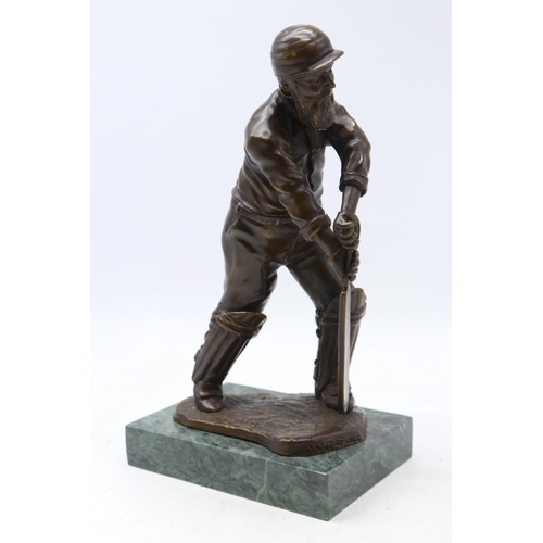 89 - A contemporary bronze figure of W.G Grace in cricketing pose on marbled base (approx. 30cm tall)