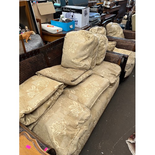 136 - Ercol, wooden framed begere settee and two armchairs, all with decorative carved frames. Note damage... 