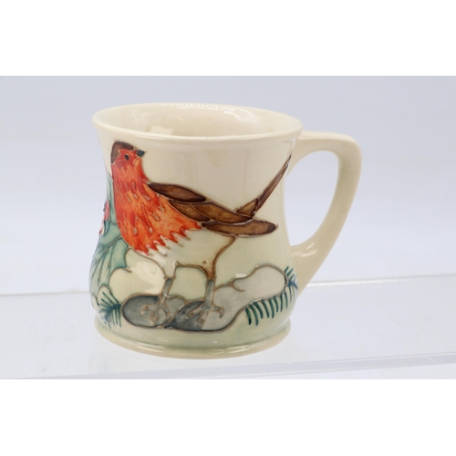 211 - A Moorcroft mug decorated with christmas Robin and holly and berry.