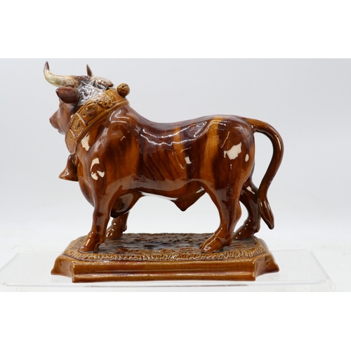 712 - Vintage, treacle glazed decanter in the form of a bull. approx. h23 x w27cm