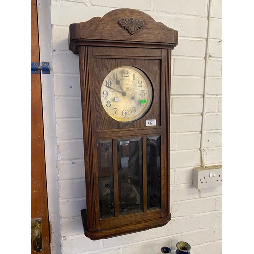 582 - An oak cased wall clock