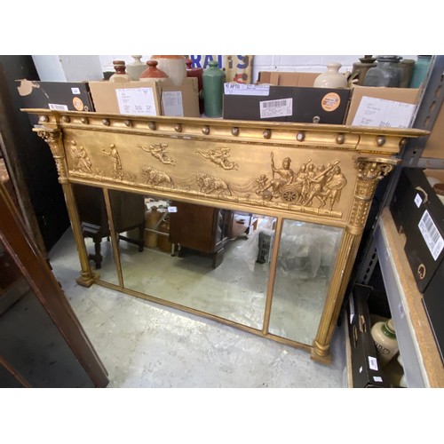 619 - A large gilt overmantle mirror with three bevel edged panes, and a raised chariot relief above