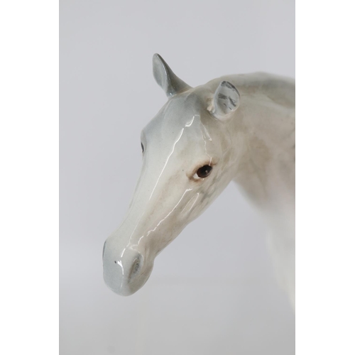 45 - Four Beswick horses including a large grey which has one ear needing repair.