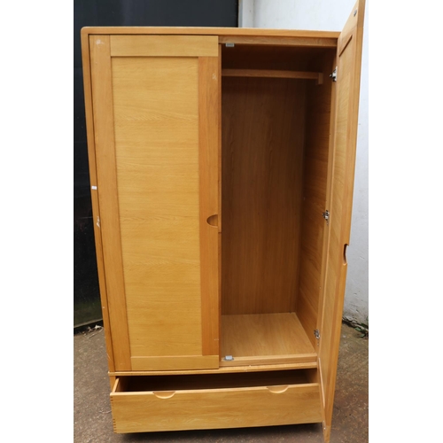 66 - An Ercol contemporary double sized wardrobe with drawer under measuring approx. 115cmW x 61cmD x 198... 
