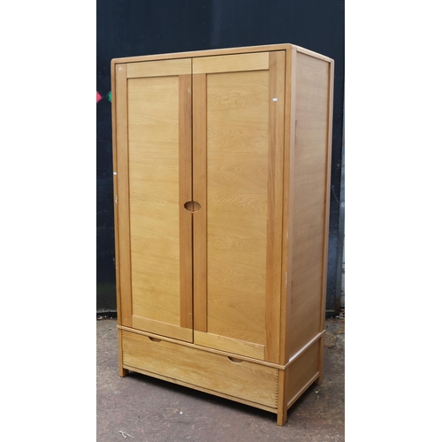 66 - An Ercol contemporary double sized wardrobe with drawer under measuring approx. 115cmW x 61cmD x 198... 