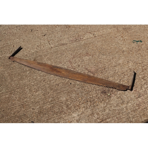 71 - A large two-handled wood saw measuring approx 178cm long.