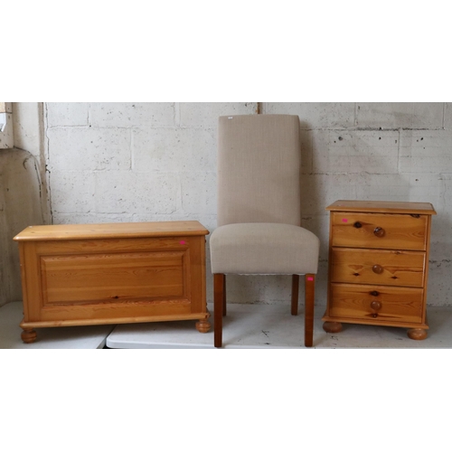 77 - Three drawer pine bedside together with a pine blanket box and a contemporary chair with biscuit col... 