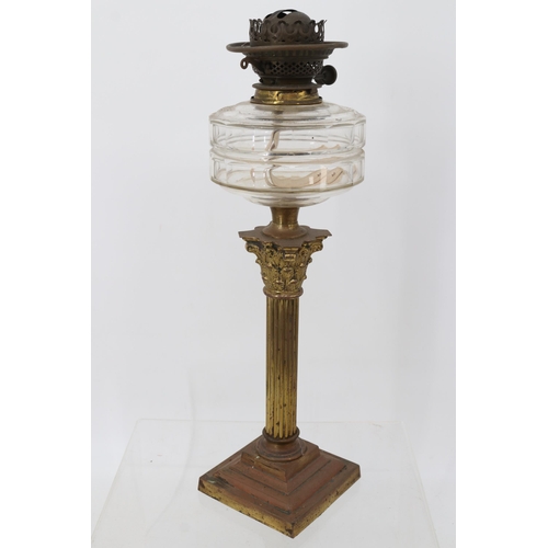 251 - An oil lamp on brass plinth - missing shade/flue