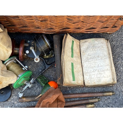 412 - A vintage wicker fishing box with reels, fly's, and other accessories together with split cane rods,... 