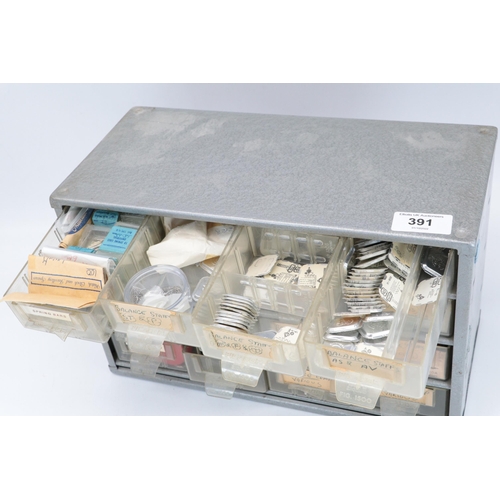 391 - Metal storage tidy drawer set, with watch interest contents, mainy balance staffs etc